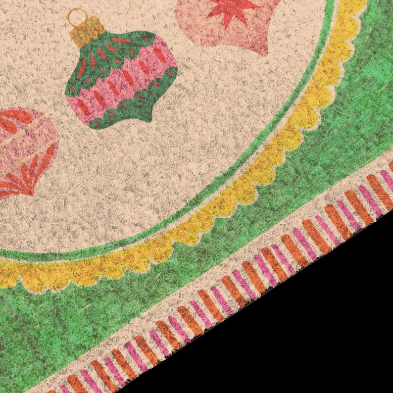May include: A textured coir doormat featuring a beige background with printed Christmas ornaments in green, pink, and red. The border consists of a scalloped yellow trim followed by a wide green band and a striped edge in orange and pink.