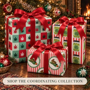 May include: Three rectangular gift boxes wrapped in patterned paper and tied with red satin ribbons. One box features a red and green cannabis leaf checkerboard pattern, another shows jars of dill pickles, and the third displays frogs on rockets.