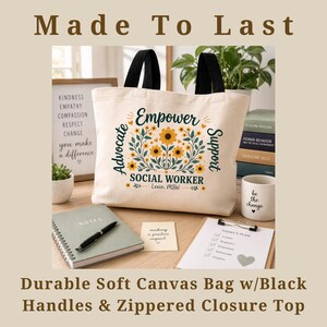 May include: Cream-colored canvas tote bag with black handles. The bag features the text "Empower Advocate Support SOCIAL WORKER" with floral accents. Additional text includes "Made To Last" and "Durable Soft Canvas Bag w/Black Handles & Zippered Closure Top".