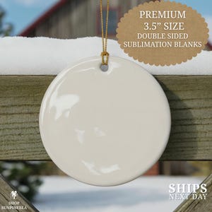 May include: A blank, off-white, round ceramic ornament with a gold string for hanging. The ornament is 3.5 inches in size and double-sided, suitable for sublimation. Text on the image reads "Premium 3.5" Size Double Sided Sublimation Blanks."