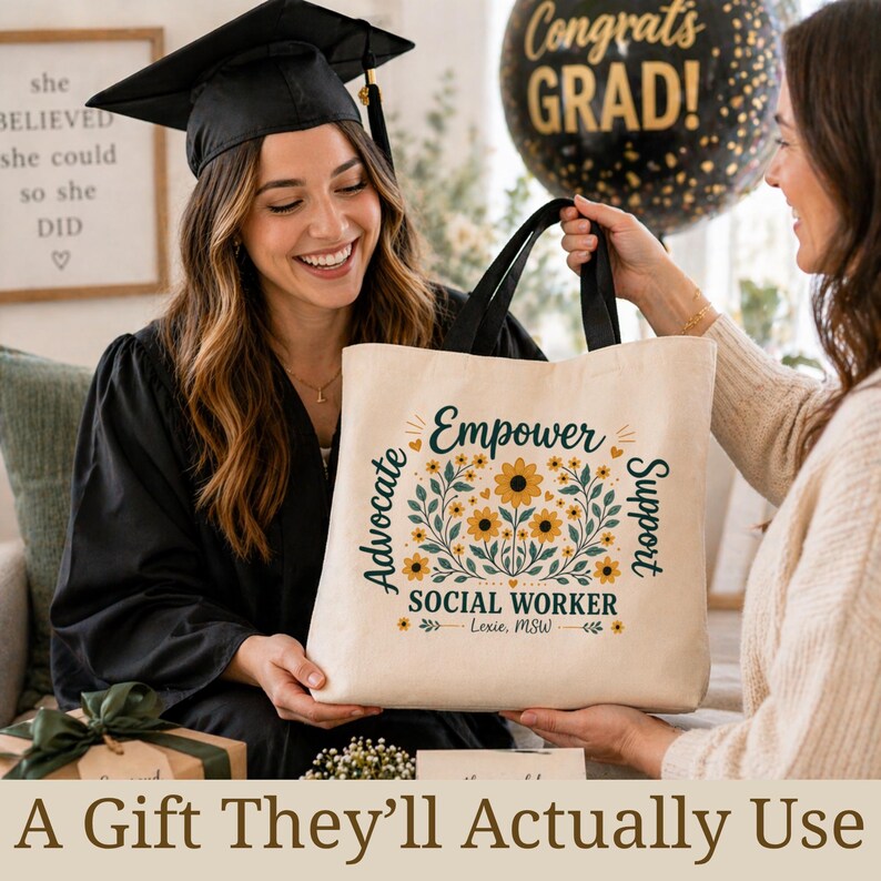 May include: A beige tote bag with black handles featuring the text "Empower Advocate Support SOCIAL WORKER" with floral accents. The image shows a graduate in a cap and gown holding the bag, with a "Congrats GRAD!" balloon in the background.