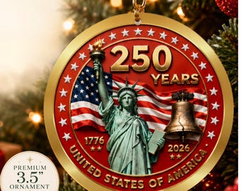 May include: A round 3.5-inch gold-rimmed ornament featuring the Statue of Liberty, a Liberty Bell, and an American flag. The text reads 250 YEARS, 1776, 2026, and UNITED STATES OF AMERICA, surrounded by a ring of white stars on a red background.