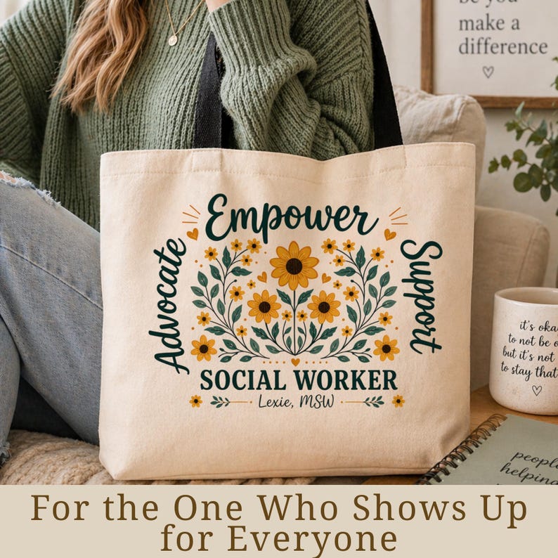 May include: Beige tote bag with the words "Empower, Advocate, Support, Social Worker" and a floral design. The bag also has the text "Lexie, MSW" and the phrase "For the One Who Shows Up for Everyone".