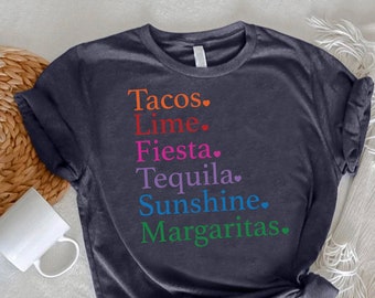 May include: A dark grey t-shirt with the text "Tacos. Lime. Fiesta. Tequila. Sunshine. Margaritas." printed in rainbow colors.