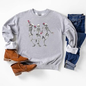 a pair of shoes and a sweater on a white surface