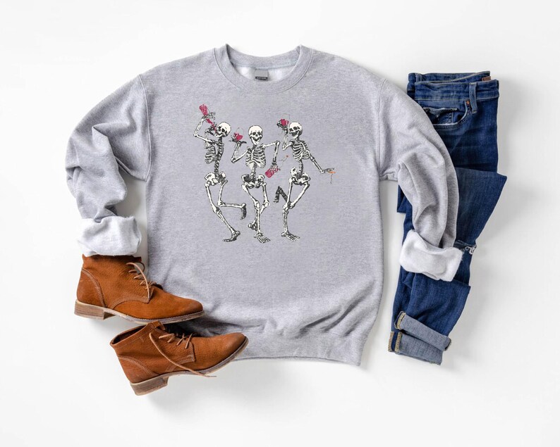 a pair of shoes and a sweater on a white surface