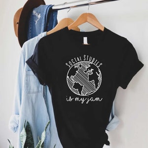 May include: Black t-shirt with a white graphic of a globe with the text "Social Studies is my jam".
