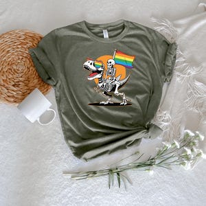 a t - shirt with a skeleton holding a rainbow flag
