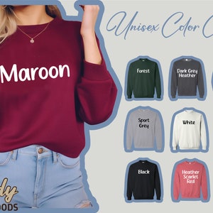 May include: A unisex colour chart for sweatshirts, showing different colours including maroon, forest, dark grey heather, sand, sport grey, white, military green, black, heather scarlet red, and red.