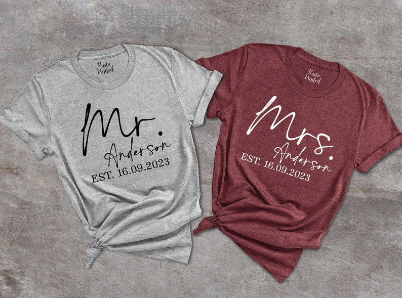 May include: Two t-shirts, one gray and one maroon, with the words "Mr. Anderson EST. 16.09.2023" and "Mrs. Anderson EST. 16.09.2023" printed on them.