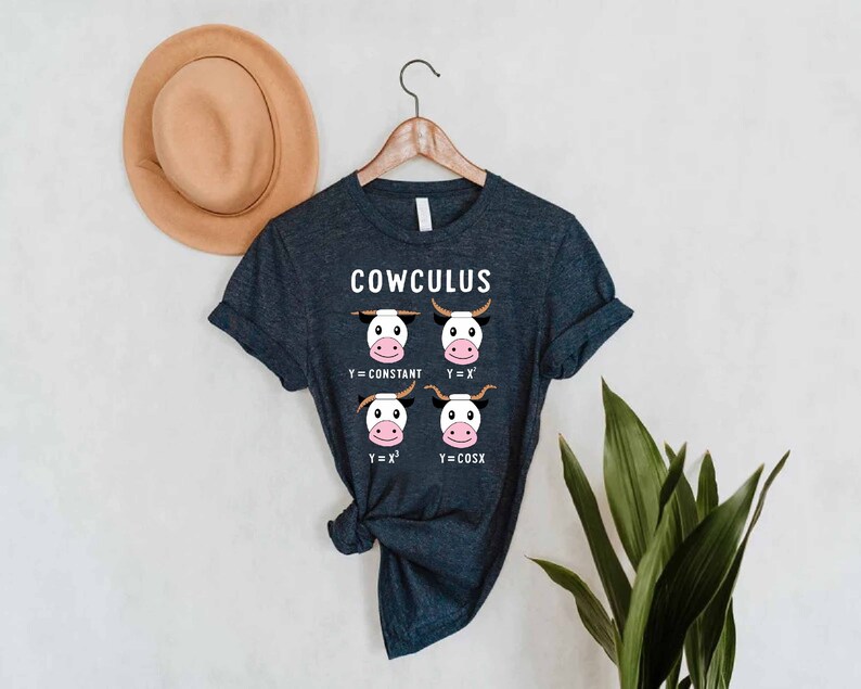 May include: A dark blue t-shirt with the text "COWCULUS" and a graphic of four cow faces with math equations: "Y=CONSTANT", "Y=X", "Y=X^2", and "Y=COSX".