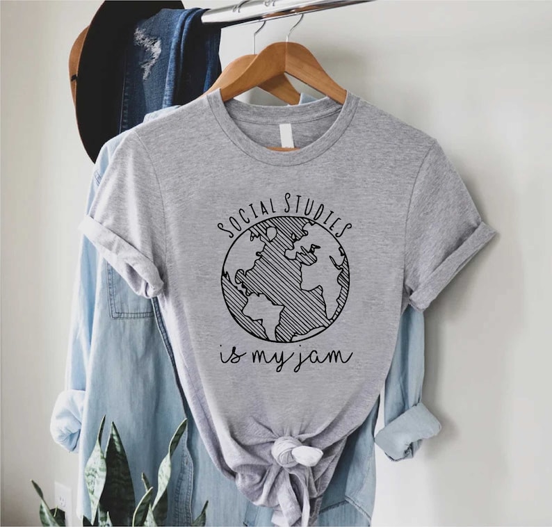 May include: A grey t-shirt with a black graphic of a globe and the text "Social Studies is my jam".