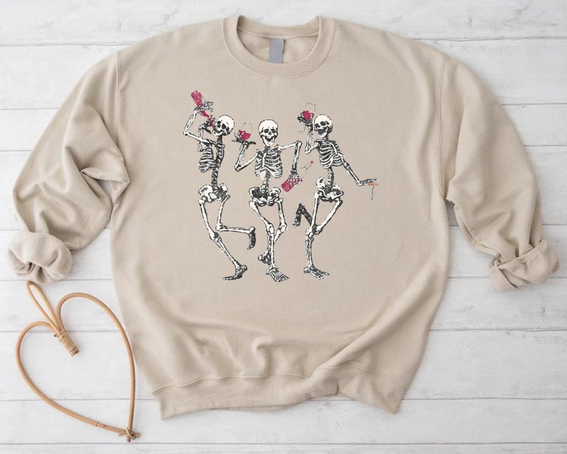 a sweater with a picture of two skeletons dancing