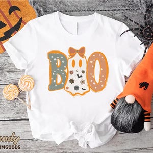a white shirt with the word boo on it