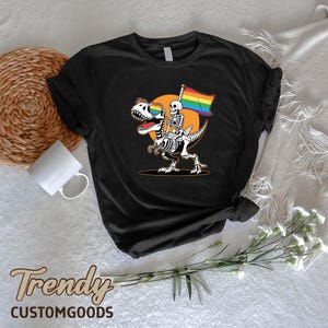 a skeleton riding a skateboard holding a rainbow flag