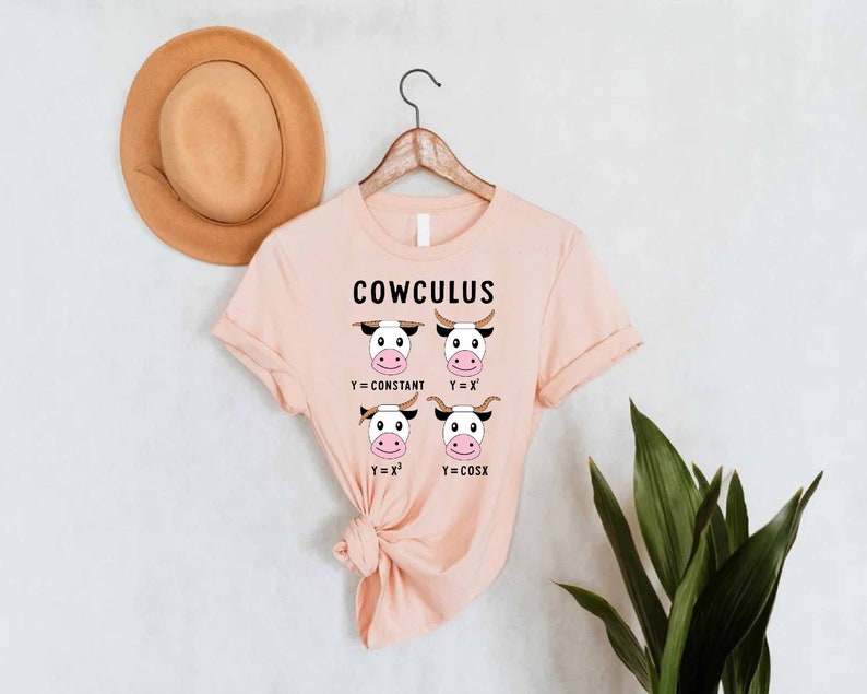 May include: A pink t-shirt with the text "COWCULUS" and a graphic of four cows with different mathematical equations. The equations are Y=CONSTANT, Y=X, Y=X^2, and Y=COSX.