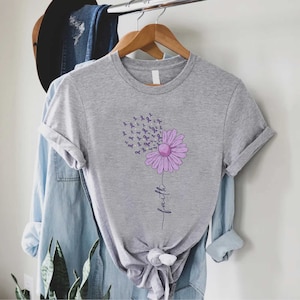 May include: Gray t-shirt with a purple flower design. The flower is made up of purple awareness ribbons and the word "faith" is written below it.