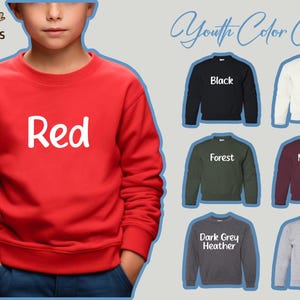 a young boy wearing a red sweatshirt with the words red on it