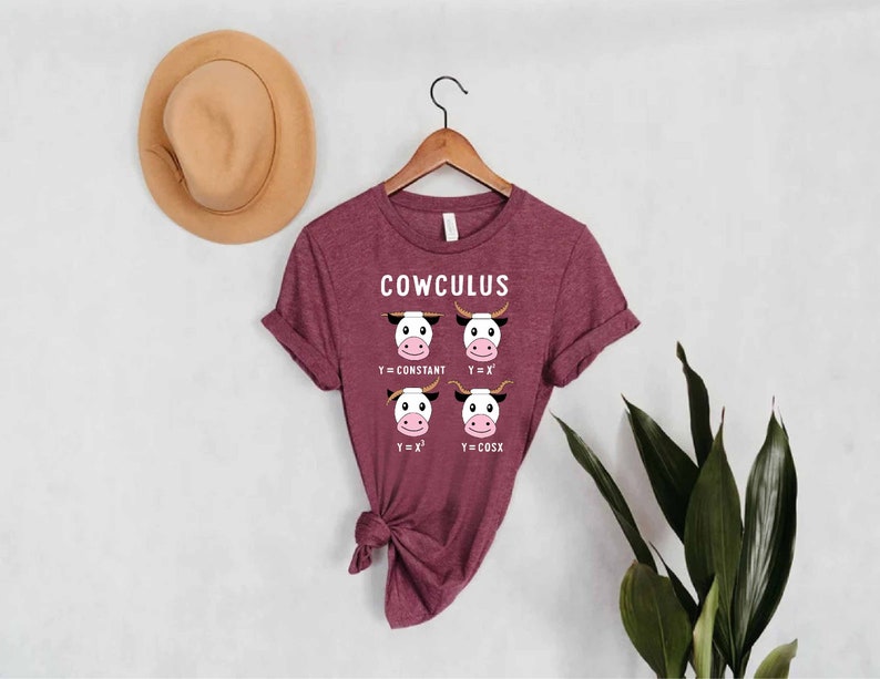 May include: A maroon t-shirt with the text "COWCULUS" and a graphic of four cows representing different mathematical equations. The equations are y=constant, y=x, y=x^2, and y=cosX.