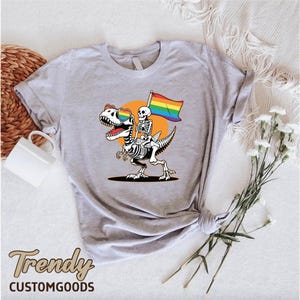 a t - shirt with a skeleton holding a rainbow flag