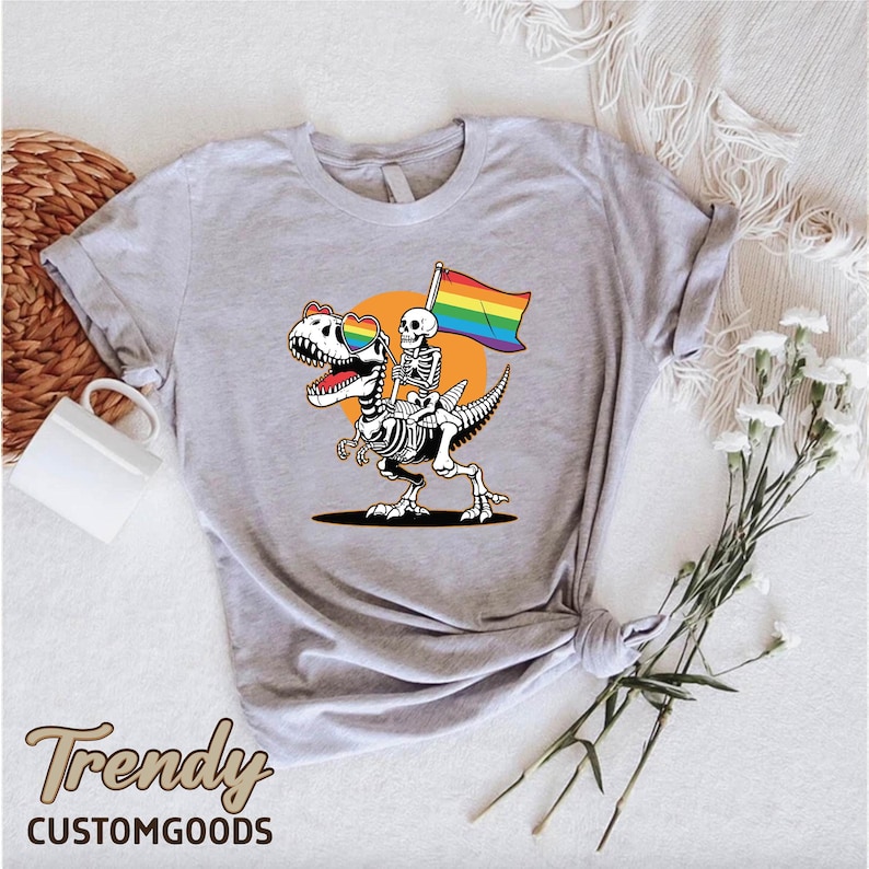 a t - shirt with a skeleton holding a rainbow flag