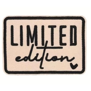 May include: A rectangular embroidered patch with a cream-colored background and a thick black border. The text "LIMITED" is stitched in bold black capital letters above the word "edition" in a black cursive script, ending with a small heart.