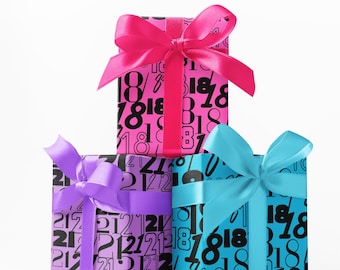 May include: Three wrapped gift boxes stacked on top of each other. The boxes are wrapped in paper with a black number pattern. Each box is tied with a satin ribbon bow in pink, purple, and blue. The background is white.