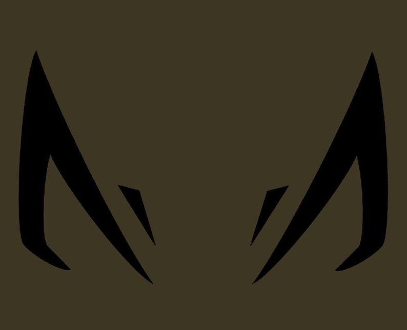 May include: Black stylized graphic of two symmetrical shapes resembling animal ears or horns, set against a muted olive-green background. The shapes have sharp angles and a modern, minimalist design.