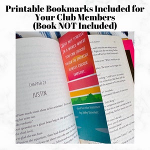 May include: A close-up of a book with a colorful bookmark. The bookmark has a rainbow design and the text "Why not forgive? In a world where you can choose anger or empathy, always choose empathy." The book is open to chapter 23, titled "Justin".