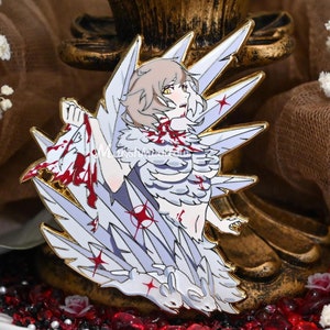 May include: A white enamel pin with a detailed illustration of a person with white wings and red blood splatters. The person is wearing a white and gray outfit with a red heart on their chest. The pin is set against a gold background.