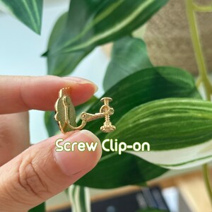 May include: Gold screw-on earring clip. The clip is designed to hold earrings in place for those with sensitive ears.
