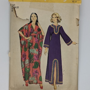 May include: Simplicity sewing pattern number 5315 for a long, flowing dress with a V-neckline and long sleeves. The pattern includes two different styles: one with a floral print and the other in a solid purple color. The pattern is for sizes 8-10.
