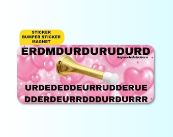 May include: A rectangular sticker featuring a pink background with a pattern of hearts and sparkles. Centered is a gold-colored spring doorstop with a white rubber tip. The text ERDMDURDURUDURD, URDEDEDDEURRUDDERUE, and DDERDEURRDDDDURDURRR is printed in black.
