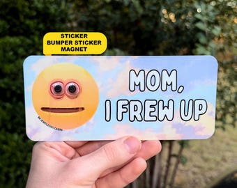 May include: A rectangular bumper sticker magnet featuring a yellow emoji with wide, bloodshot eyes and a flat mouth. The background is a light blue sky with soft clouds. The text reads, "MOM, I FREW UP" in bold black letters.