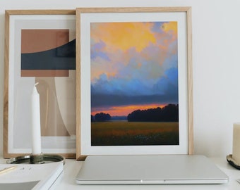 May include: A framed print of a landscape painting with a sunset sky and a field of grass. The sky is a mix of orange, yellow, blue, and purple. The grass is green and there are trees in the distance.