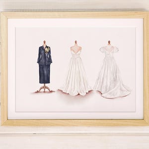 May include: Framed print featuring three watercolor illustrations of formal wear. A navy blue suit with a floral accent, and two white wedding dresses. The dresses are displayed on dress forms.