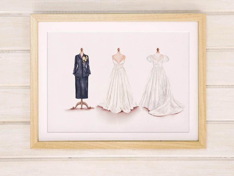 May include: Framed print featuring three watercolor illustrations of formal wear. A navy blue suit with a floral accent, and two white wedding dresses. The dresses are displayed on dress forms.