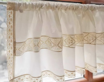 May include: White sheer valance with a delicate lace trim. The lace trim features a repeating pattern of small flowers and geometric shapes.