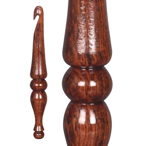 May include: A set of two wooden crochet hooks with a dark brown wood grain finish. The larger hook has a bulbous handle with three rounded sections. The smaller hook has a more traditional handle with two rounded sections.