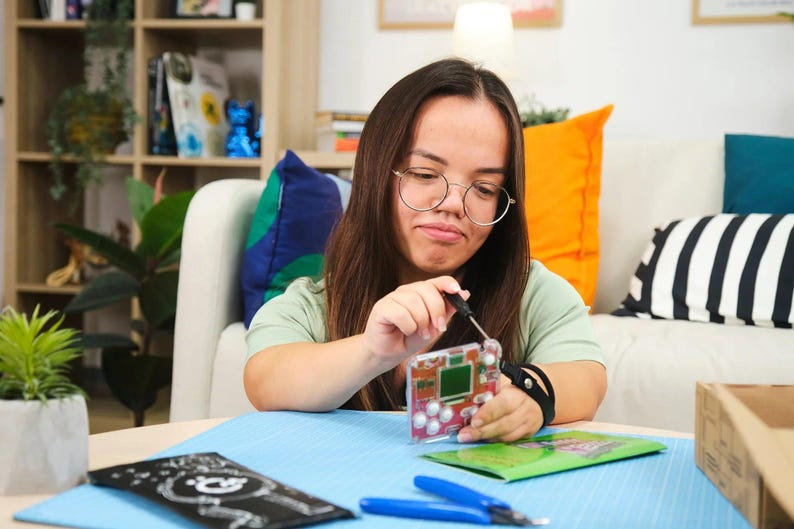 Woman playing with CircuitMess Bit 2.0