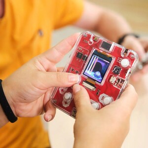 Woman playing with CircuitMess Bit 2.0