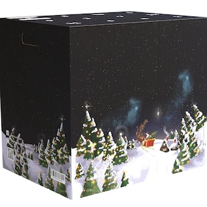 May include: A large, square box with a Christmas-themed design. The box features a dark night sky with falling snow and a winter landscape with Christmas trees and Santa's sleigh. The box has a handle on top.