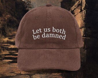 May include: Brown corduroy baseball cap with the embroidered text "Let us both be damned" in white. The cap has a curved brim and a classic six-panel design. The hat is a stylish accessory.