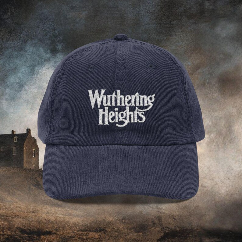 Navy Blue cotton corduroy baseball cap with adjustable strap and white embroidered text reading 'Wuthering Heights' inspired by the book Wuthering Heights By Emily Brontë.