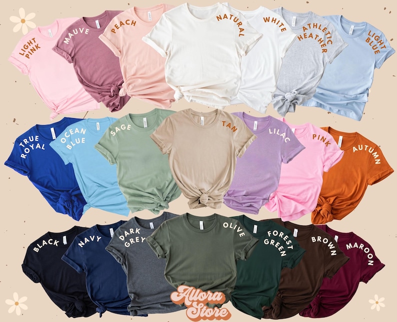 May include: A selection of short-sleeved t-shirts in a range of colours, such as pink, blue, and green. Each shirt has a different colour name printed on the sleeve. The shirts are displayed in rows, showcasing a variety of shades.