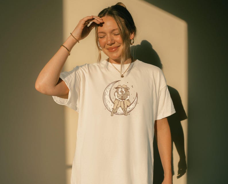 Two Sapphic Lesbian Cowgirls Sitting On Crescent Moon White Short Sleeve T-Shirt