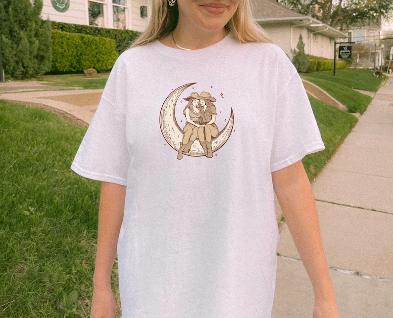 Two Sapphic Lesbian Cowgirls Sitting On Crescent Moon White Short Sleeve T-Shirt
