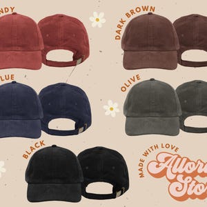 May include: A selection of corduroy baseball caps in shades of burgundy, dark brown, navy blue, olive, and black. Each cap is displayed from the front and back, with an adjustable strap. The text "Burgundy", "Dark Brown", "Navy Blue", "Olive", and "Black" are shown.