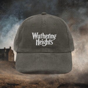 Olive Green cotton corduroy baseball cap with adjustable strap and white embroidered text reading 'Wuthering Heights' inspired by the book Wuthering Heights By Emily Brontë.