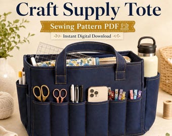 May include: A dark blue fabric craft supply tote with 15 exterior pockets, featuring the text 15 Pocket Craft Supply Tote Sewing Pattern PDF Instant Digital Download. The tote holds scissors, pens, a smartphone, and clips, with a water bottle in a side pocket.